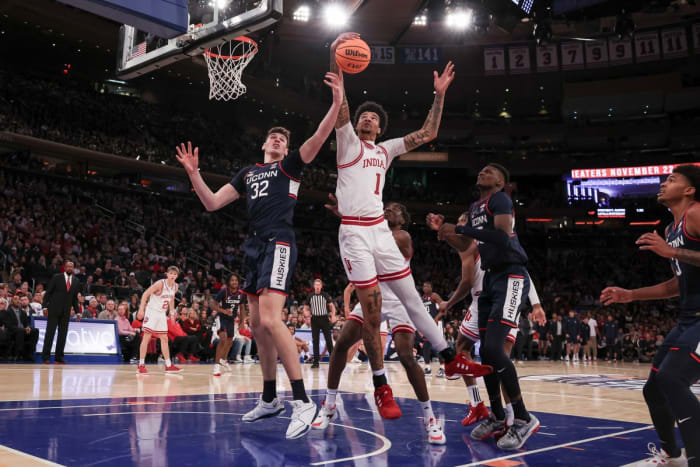 Indiana Hoosiers center Kel'el Ware (1) rebounds against Connecticut Huskies center Donovan Clingan (32) and forward Samson Johnson (35) during the first half at Madison Square Garden.